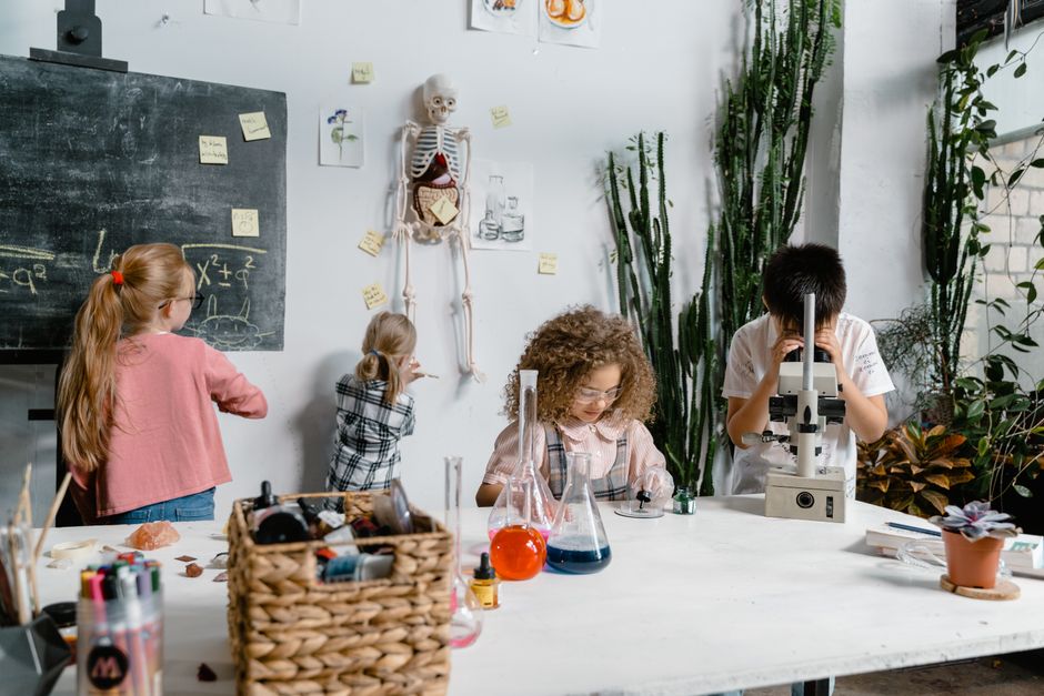 Children conducting a science experiment in a classroom.