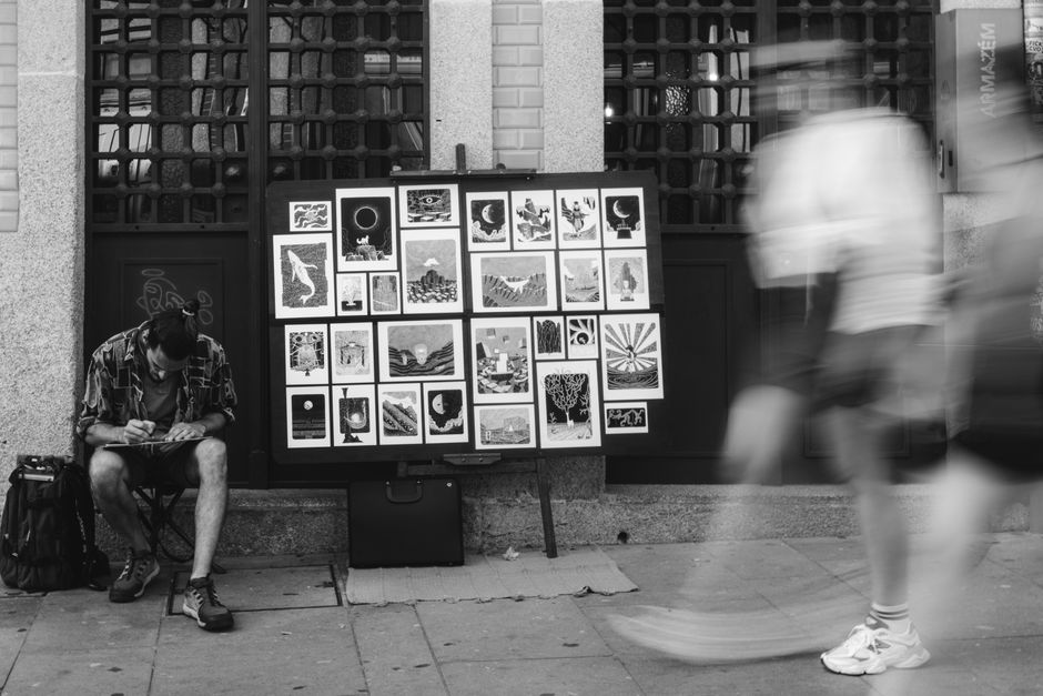 A street artist creating art, representing zine and art festival culture.
