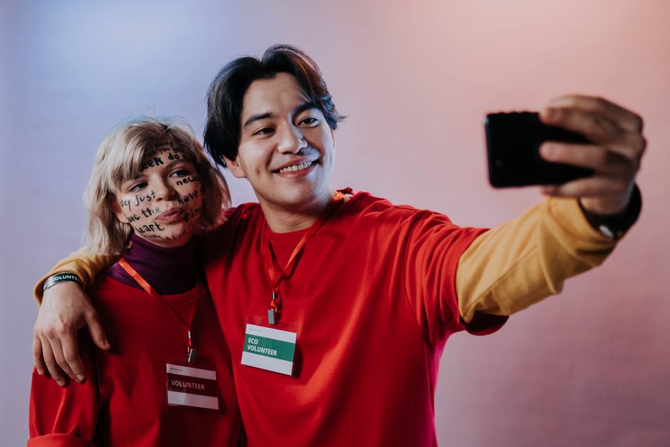 Two volunteers taking a selfie together, representing community involvement.